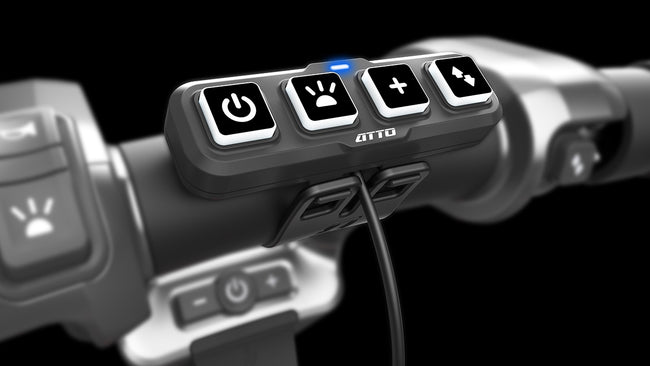ATTO mobility scooter handlebar control panel with power, speed, and function buttons.